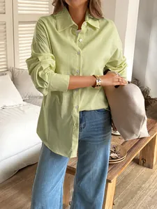 Detailed view of women's lime green linen-textured long-sleeve button-down shirt