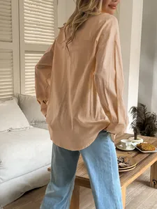 Rear view of a casual peach long-sleeve women's shirt showing soft fabric texture