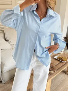 Casual light blue solid color long-sleeve button-down shirt for women in lifestyle setting