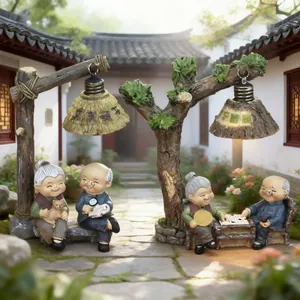Intricate resin elderly couple figurines set within a miniature Chinese courtyard