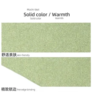 Soft green wool knit triangle scarf featuring fine edge binding and premium texture