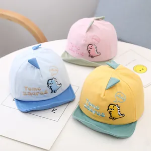 Cute baby baseball caps with dinosaur embroidery in pink, blue, and yellow colors