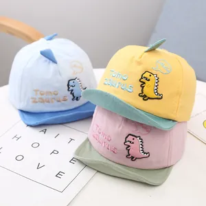 Set of three colorful infant baseball caps with cute embroidered dinosaur designs.