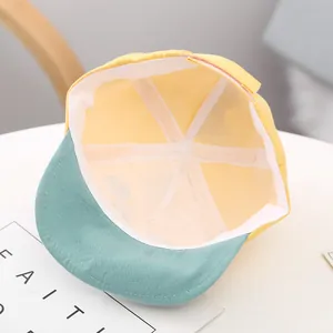 Interior detail of cute yellow and green baby baseball cap with soft cotton lining