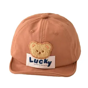 Adorable terracotta brown baby baseball cap featuring a cute teddy bear embroidery patch