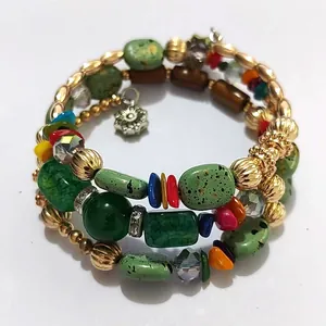 Close-up of retro multilayer wrap bracelet with green turquoise stones and colorful beads