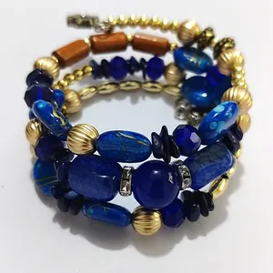Detailed view of bohemian multi-layer wrap bracelet with blue turquoise and gold beads