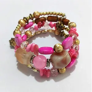 Detailed view of a vintage multilayer beaded wrap bracelet featuring pink stones and gold accents.