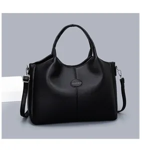 Detailed macro view of black pebbled leather tote bag with elegant silver-tone hardware