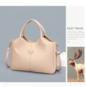 Detailed view of a beige retro large capacity women's handbag with adjustable shoulder strap