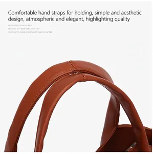 Macro detail of high-quality brown leather handbag handle with durable stitching work