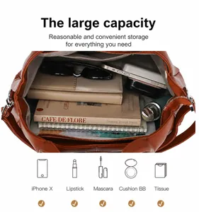 Close-up interior of large brown vintage handbag with various daily essentials