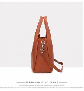 Side view of a stylish brown vintage handbag with silver hardware and shoulder strap