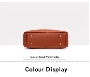 Detailed bottom view of a retro brown leather handbag with four metal protective feet