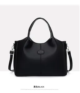 Close-up view of a vintage black leather tote bag with a sleek minimalist design