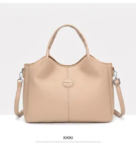 Elegant front view of khaki vintage handbag with top handles and shoulder strap