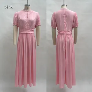 Detailed front and back view of elegant pink V-neck maxi dress with lace trim and pleated waist