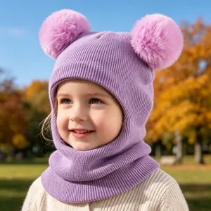 Detailed view of a child wearing a cozy purple knit integrated hat with pink pom-poms.