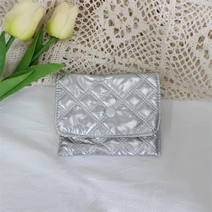 Detailed view of a metallic silver quilted PU coin purse with a secure snap button closure
