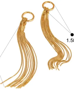 Close-up of gold snake bone chain tassel earrings with knotted design details.