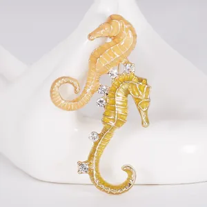 Charming dual seahorse brooch with yellow enamel and sparkling rhinestones accessory.