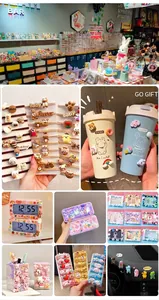 Close-up of various cartoon resin charms applied on phone cases and stationery items