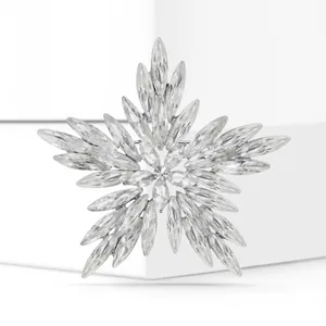 Detailed close-up of a sparkling crystal snowflake brooch with marquise-cut stones