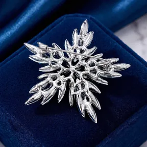 Detailed back view of silver snowflake brooch Christmas pin for sweaters and suits