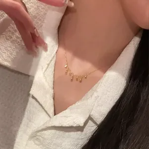 Minimalist gold clavicle chain with multiple delicate droplet-shaped pendants
