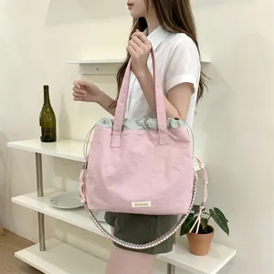 Modern pink canvas tote bag carried by a woman in a minimalist room
