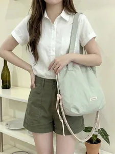 Casual mint green canvas tote bag with unique woven strap for women's daily use