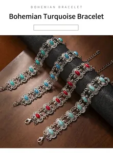Detailed view of vintage Bohemian silver bracelets with turquoise and red stones on display