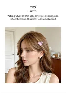 Detail view of a sweet purple acetate heart-shaped small hair claw clip on model's hair