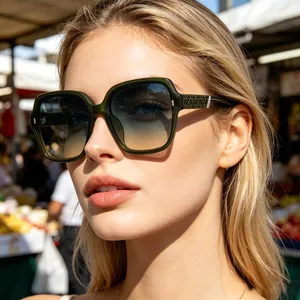 Close-up of stylish woman wearing oversized dark green polarized sunglasses outdoors
