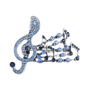 Detailed view of an elegant silver musical note brooch with sparkling blue rhinestones