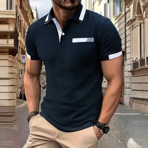 Close-up detail of slim-fit navy blue men's polo shirt with contrast collar and cuffs.