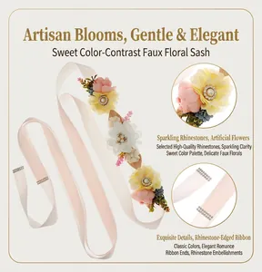 Detailed close-up of a bridal floral sash featuring soft pink ribbon and rhinestones.