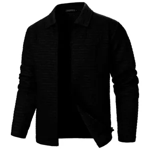 Detailed view of men's dark waffle-grid jacket with lapel collar and front zipper.