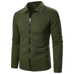 Detail of waffle knit fabric and zipper on olive green men's long sleeve jacket