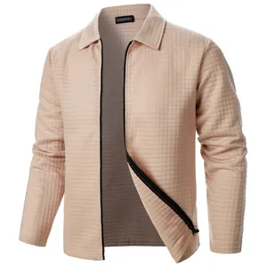 Macro view of the textured waffle knit fabric on this men's beige zip-up casual jacket