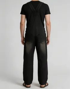 Back view of men's vintage black denim overalls with crisscross straps and pockets.