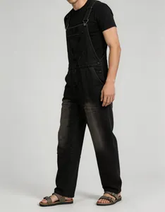 Side profile showcase of men's vintage black denim overalls paired with a black t-shirt