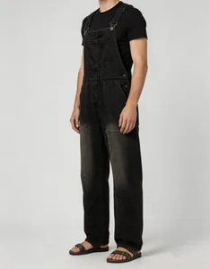 Full-length side view of men's vintage washed black denim overalls with straps