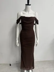 Detail of the elegant dark brown mesh ruched off-the-shoulder bodycon maxi dress.