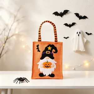 Orange Halloween burlap tote bag featuring a gnome holding a pumpkin for candy