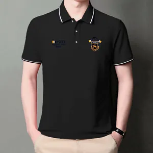 Close-up of black men's Polo shirt featuring detailed chest embroidery and striped collar