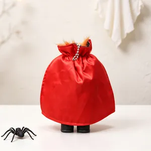 Detail of headless Halloween demon ornament with red satin cape and fur trim.