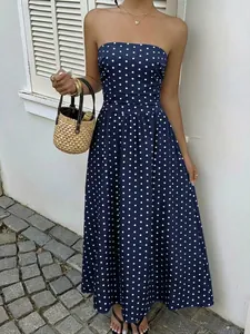 Close-up of navy blue strapless dress with elegant white polka dots and ruched waist