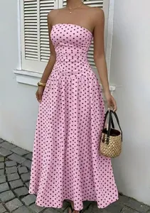 Detailed view of pink strapless polka dot dress with elegant waist-slimming A-line cut.