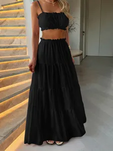 Close-up detail of the ruffled waist and tiered texture of this black vacation maxi skirt